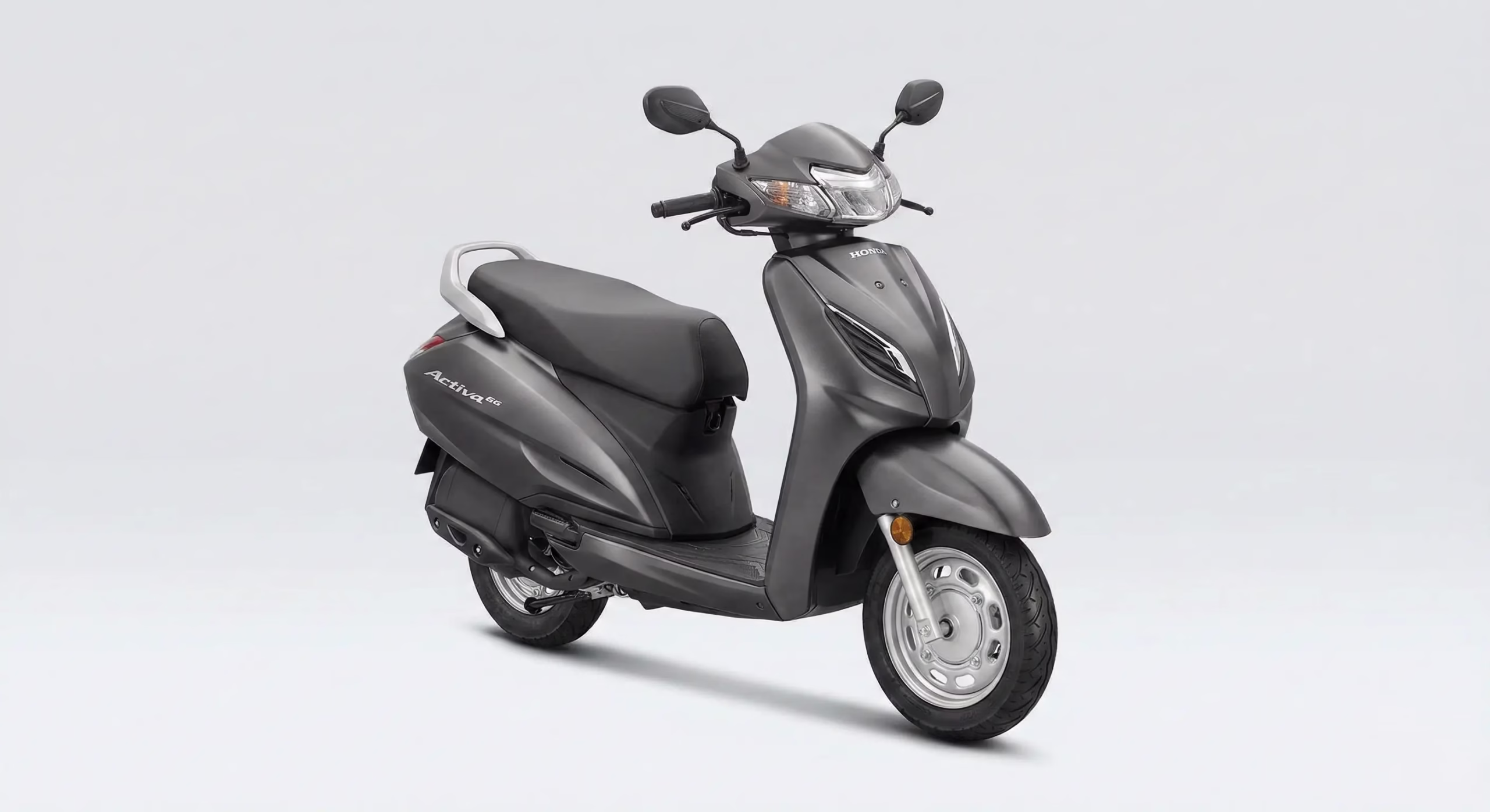Honda Activa 6G full body shot in matte grey showing metal body and new design 2026 — comparing petrol Activa heritage with Honda's new electric scooter direction
